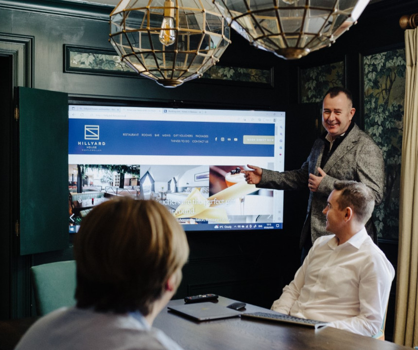 Businessman conducting a presentation in a boardroom with attentive audience